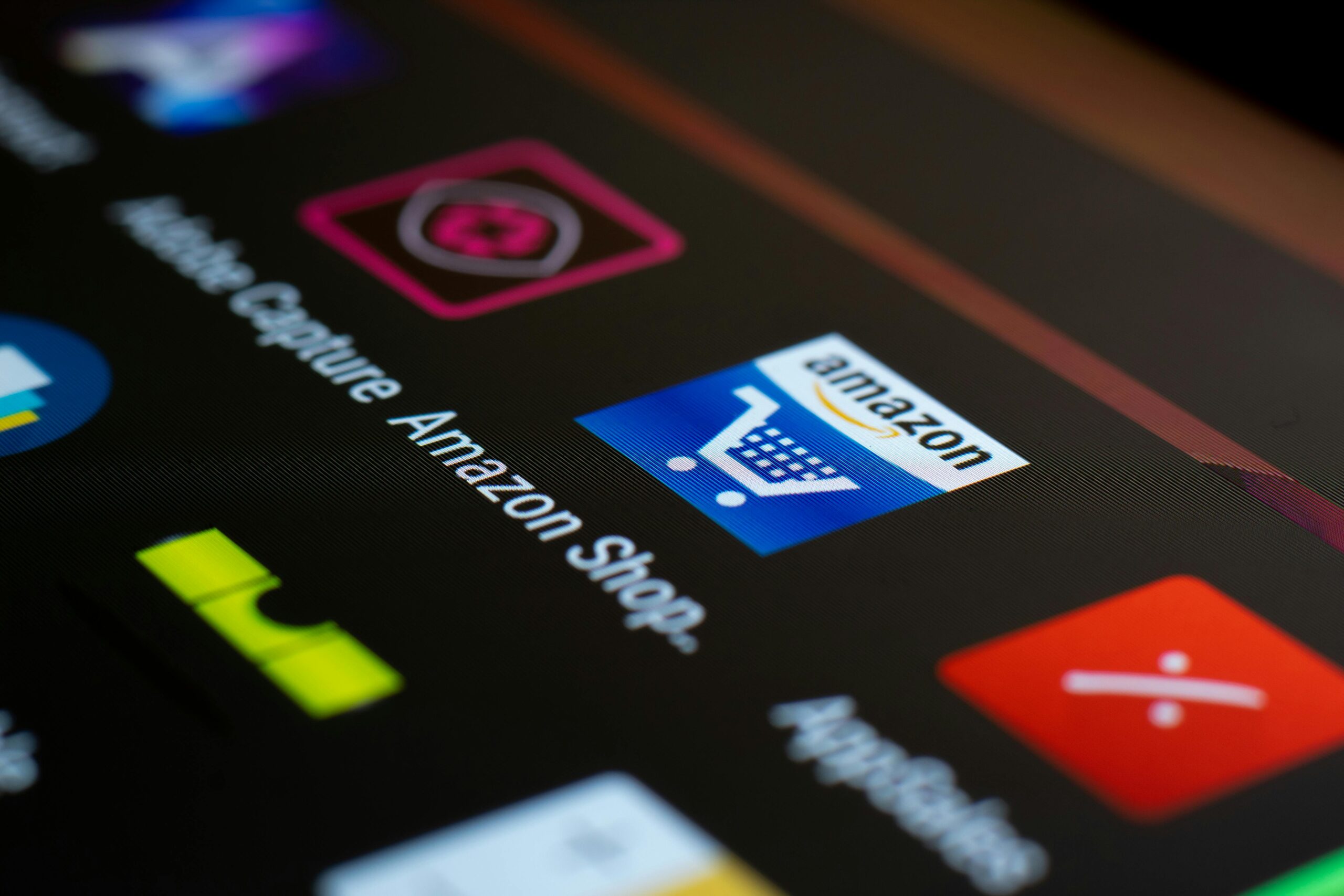 Close-up of the Amazon shopping app icon on a smartphone screen. Ideal for online shopping and technology themes.